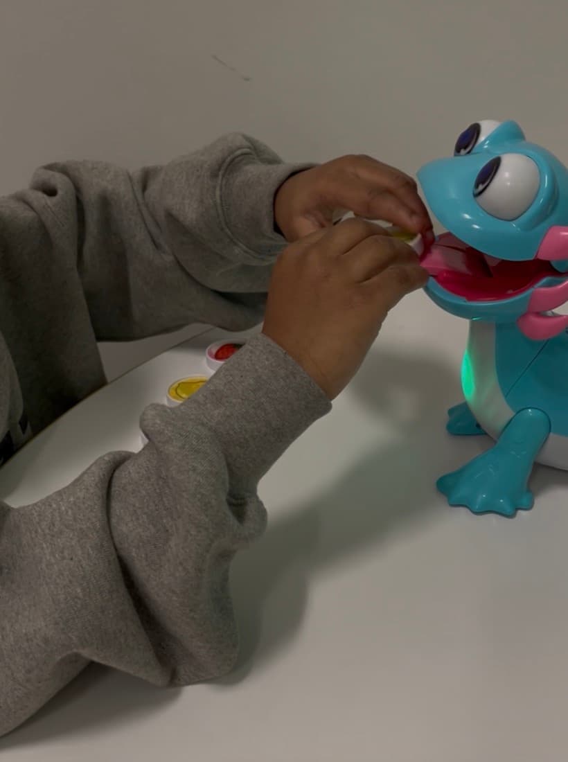 Hands playing with a toy during speech therapy