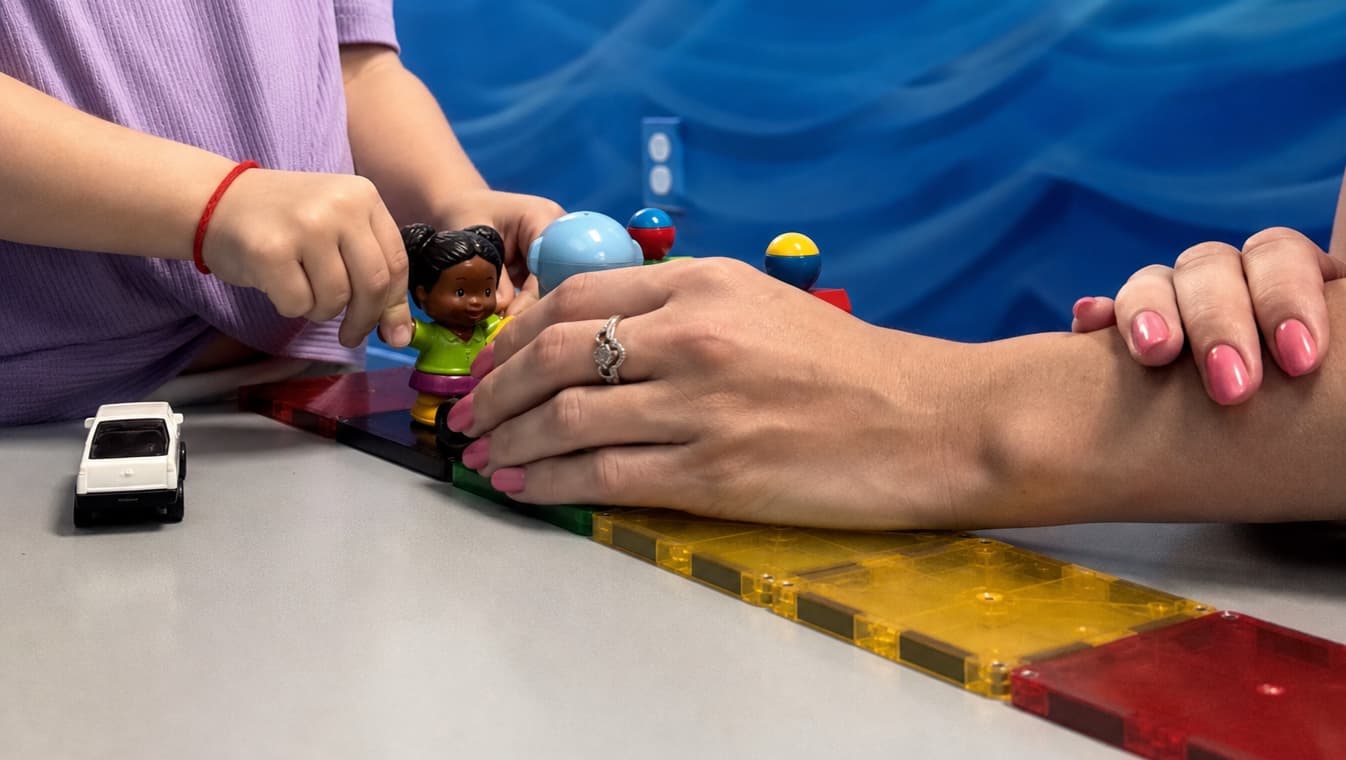 Hands using pretend-play materials during speech therapy